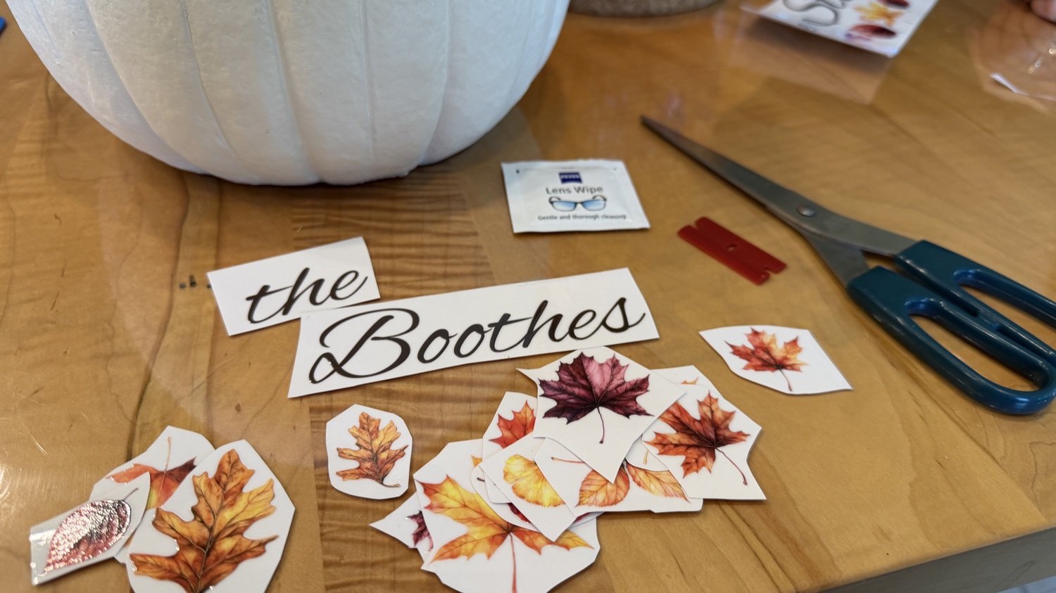 Boothes family-name transfer and fall leaf stickers laid out with crafting supplies